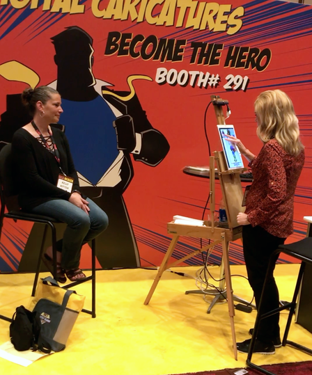Rachel murphy drawing digital super hero caricatures for a trade show in New York