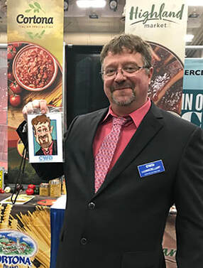 Picture Drew  Digital Caricatures Cash-Wa Distributing Trade Show Kearney Nebraska  the end of a slow lane to draw foot traffic to booths that typically don't get the foot traffic wearing their Caricatures/lanyards direct them down the slow lane Creating more foot traffic ​